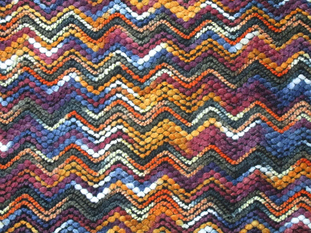 Kabátovina VOLVO "pomarančovo-vínový cik - cak"